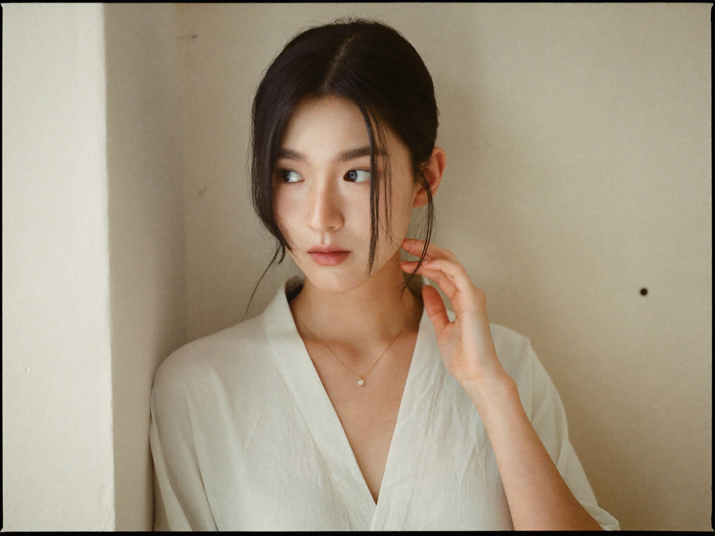 NOMAD guest with radiant smooth skin in a calm aesthetic Kuala Lumpur studio setting